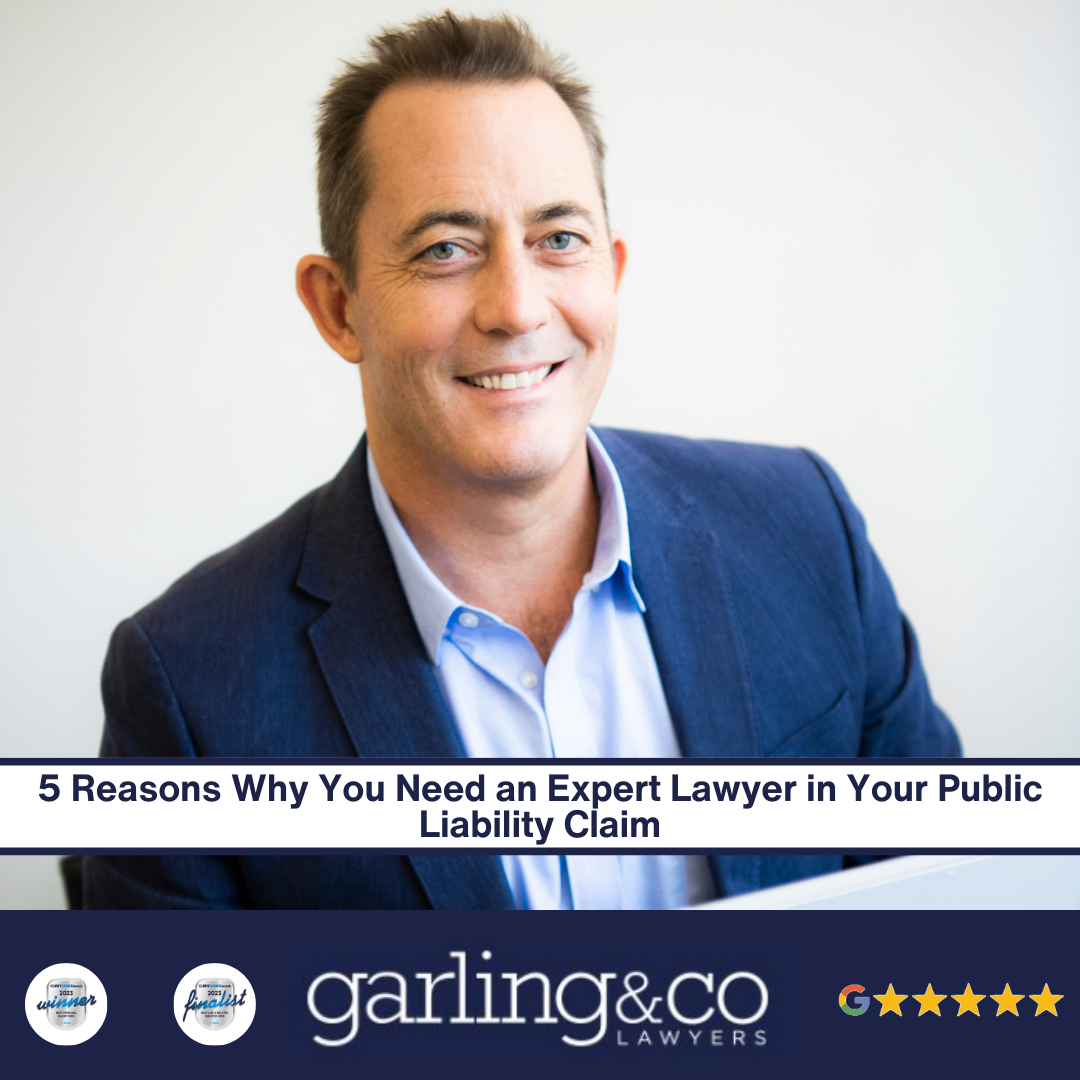 Man in a blue shirt and blue suit jacked smiling with the caption "5 Reasons Why You Need an Expert Lawyer in Your Public Liability Claim"