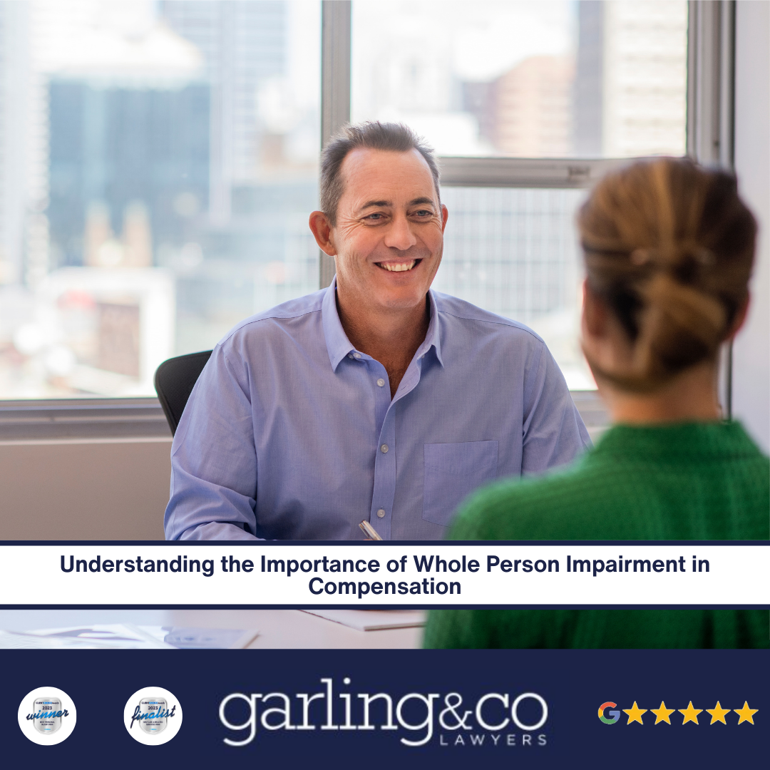 A man smiling on an opposite side of a desk to a lady.